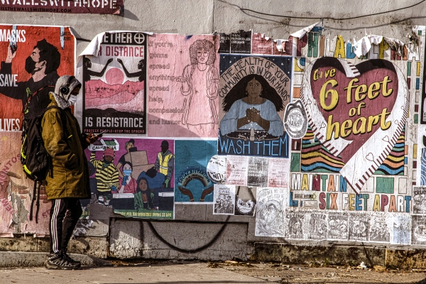 Person standing in front of wall with posters